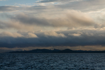 The coastline of Vladivostok from the sea. Vladivostok in inclement weather. The sea facade of Vladivostok.