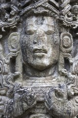 Fototapeta na wymiar Mayan Face Carved in Stone Temple Building in World Famous Copan Ruins Archeological Site of ancient Maya Civilization, a UNESCO World Heritage Site in Honduras near Guatemala Border