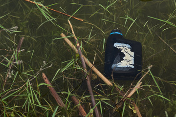 Lake pollution with plastic bottle, outdors, close-up