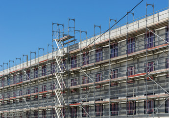 building under construction - facade with scaffolding