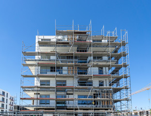 building under construction - facade with scaffolding