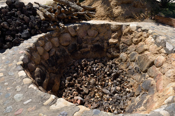 In ground oven pit for baking blue agave hearts at a Tequila factory Jalisco Mexico