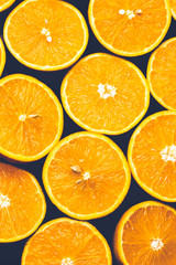 Orange background. Closeup of half cut fruits