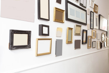 Fototapeta na wymiar various many blank small picture frames on white wall, vintage retro design