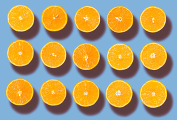 Background of half cut organic oranges in row