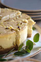 Celebratory Cheesecake on a table in a cafe. Mango and c Pistachios cheesecake. 