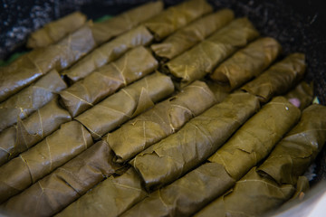 Dolma, stuffed grape leaves with rice and meat. Top view. Delicious and healthy food. Grape leaves. cooking of meal dolma.