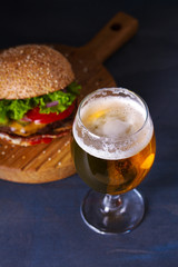 Glass of beer and burger. Beer and food concept