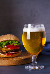 Glass of beer and burger. Beer and food concept