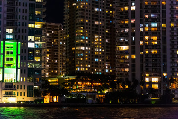 Skyscrapers by the water in Miami Riverwalk at night