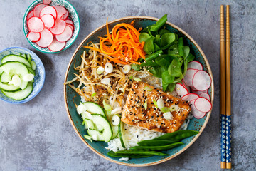Salmon teriyaki with pickled carrots and radishes, lamb lettuce and avocado