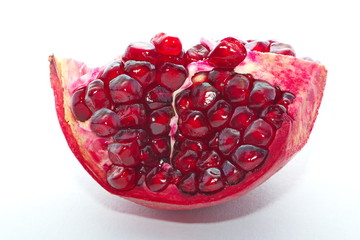 Ripe pomegranates in cut form on a white background