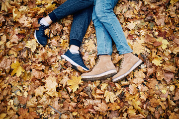 Legs of a guy and a girl resting in the park