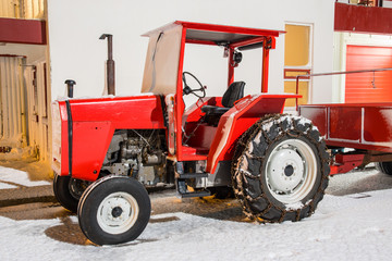 Red tractor on a snowy day