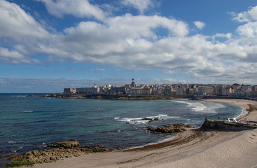 Fototapeta na wymiar Beautiful view of the beaches of Riazor and Orzán in A Coruña, Galicia with the buildings of the city and the promenade.
