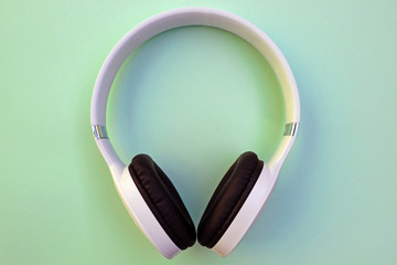 Wireless headphones are black with white on a green background.  