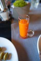 Glass with carrot juice on the table