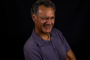 Obraz premium Portrait of a Middle Aged Mature Man Aganist a Black Background