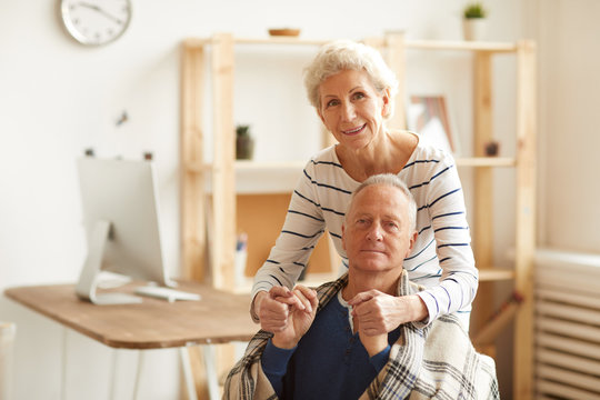 Waist Up Portrait Of Happy Senior Couple Looking At Camera In Sunlight With Wife Embracing Husband, Copy Space