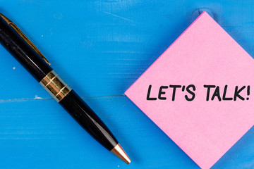Writing note showing Let S Talk. Business concept for they are suggesting beginning conversation on...