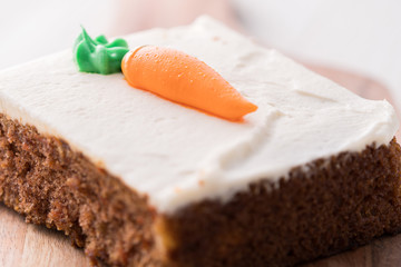 Carrot cake slice with frosting carrot topper