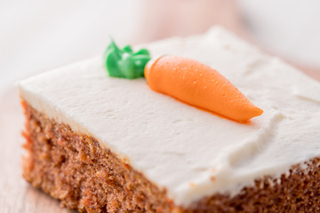 Carrot cake slice with frosting carrot topper