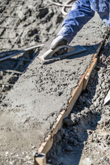 Pool Construction Worker Working With Wood Float On Wet Concrete