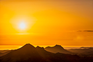 Orange sunset over Silhouetted Mountains