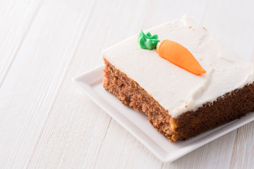 Carrot cake slice with frosting carrot topper