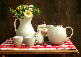 Classic vintage still life of summer bouquet, morning coffee and coffee grinder.