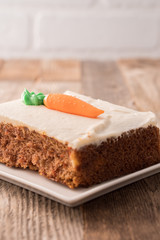 Carrot cake slice with frosting carrot topper