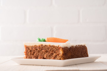 Carrot cake slice with frosting carrot topper