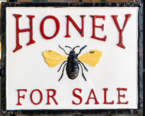 Honey for sale sign with a bee as symbol