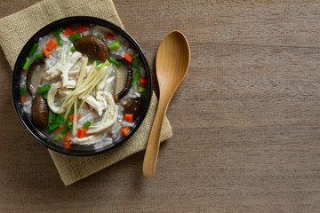 top view of boiled rice with chicken in a ceramic bowl on wooden table. asian homemade style food concept.