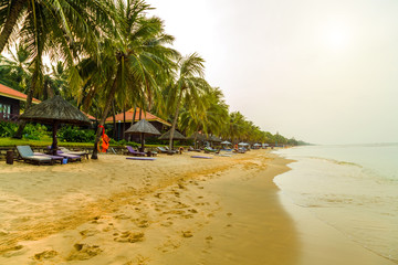 Deckchairs and parasol tropical beach sea landscape, romantic paradise