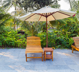 Deckchairs and parasol tropical beach sea landscape, romantic paradise