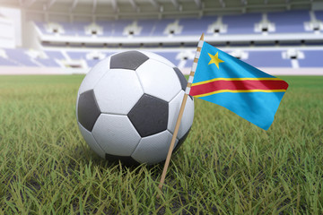 Naklejka premium Democratic Republic of the Congo flag in stadium field with soccer football