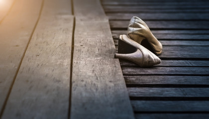 Fototapeta na wymiar Bridal shoes on the aisle wood 