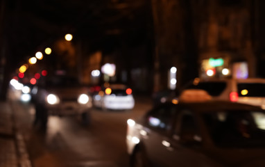 Fototapeta na wymiar Blurred view of city street with traffic at night