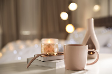 Composition with cup of drink on table against blurred background. Space for text