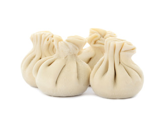 Heap of raw dumplings with tasty filling on white background