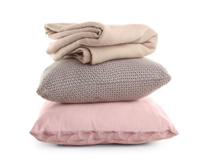 Stylish soft pillows and folded plaid on white background