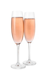 Glasses of rose champagne isolated on white