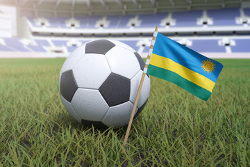 Rwanda flag in stadium field with soccer football