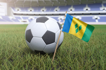 Saint Vincent and the Grenadines flag in stadium field with soccer football