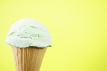 Ice-cream scoop in waffle ice cream cone with copy space. Summer background, vacation, refreshment, traditional seasonal cold sweets
