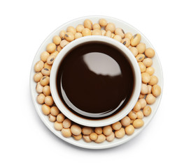 Dish of soy sauce with beans on white background, top view