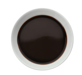 Bowl of soy sauce on white background, top view