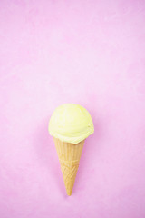 Ice-cream scoop in waffle ice cream cone on bright pink background. Summer, heat, vacation, refreshment, traditional seasonal cold sweets