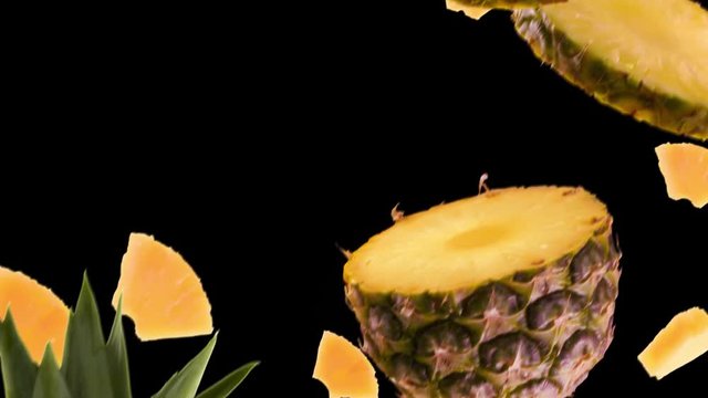 Pineapple with Slices Falling on Black Background